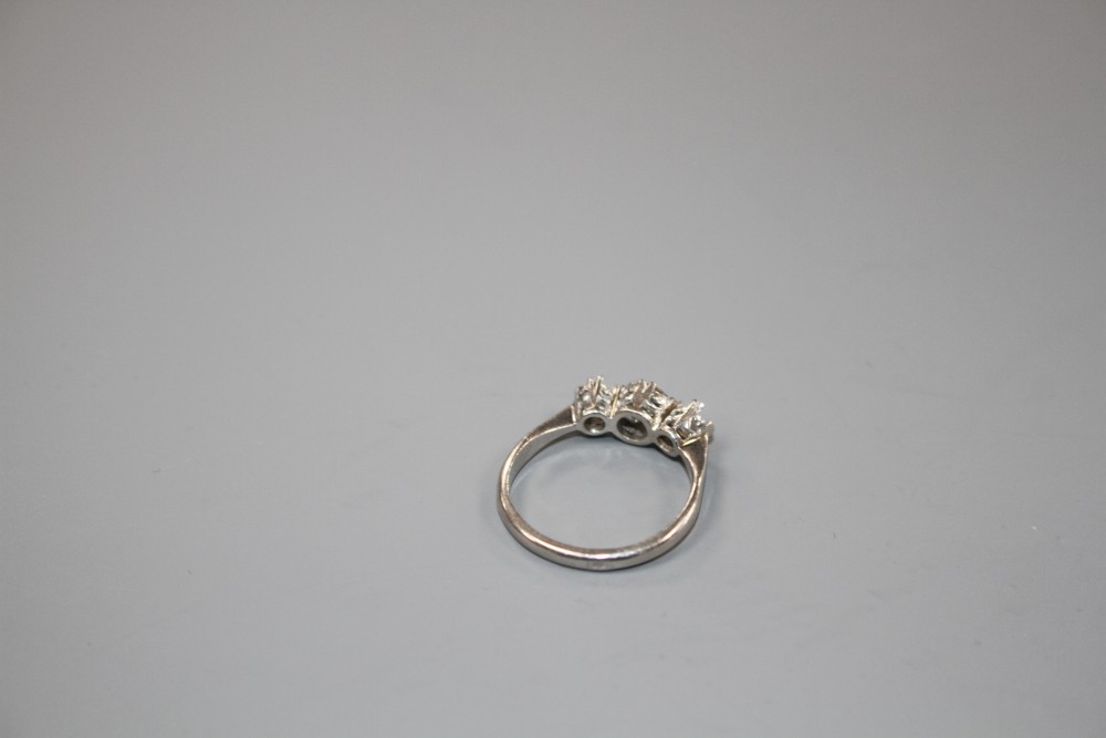 A white metal and single stone (ex three stone) diamond ring,